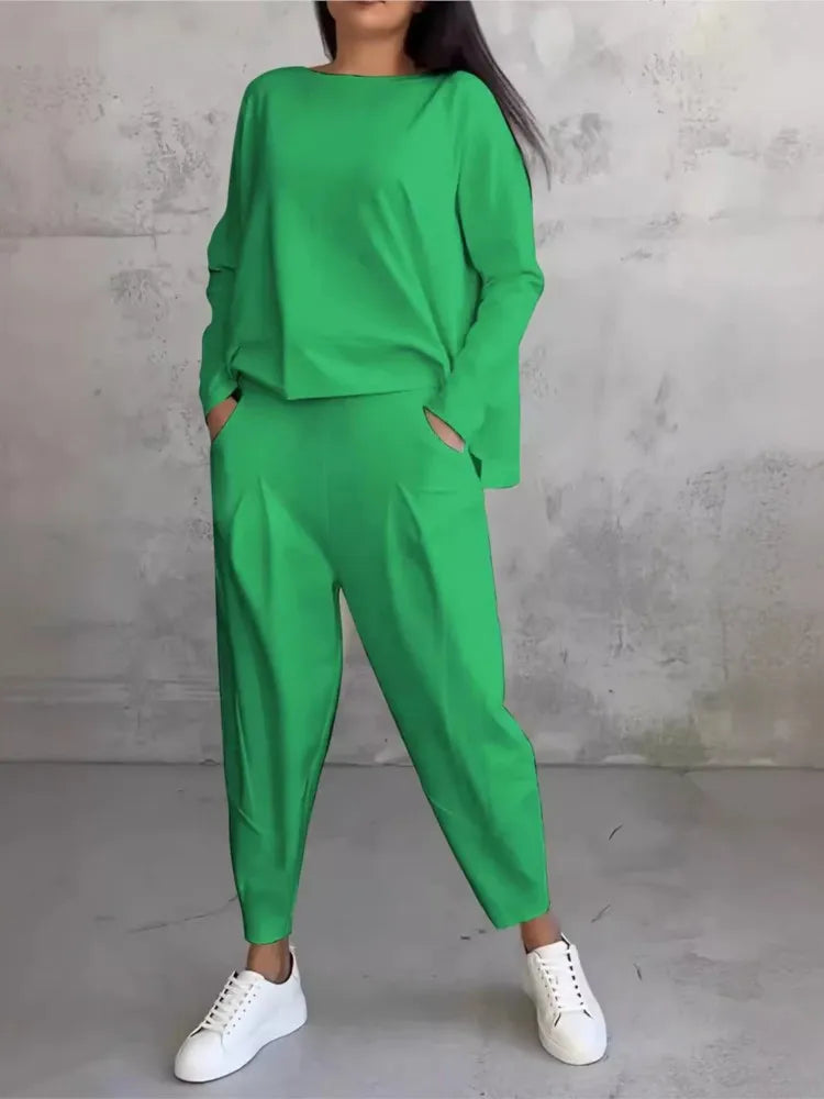 Elevate your casual style with this luxurious women's sports set featuring a loose long sleeve irregular top in elegant hues.