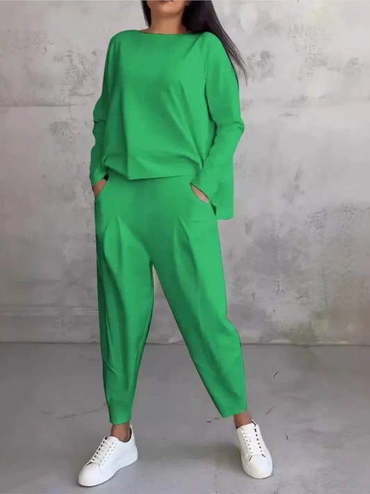 Elevate your casual style with this luxurious women's sports set featuring a loose long sleeve irregular top in elegant hues.