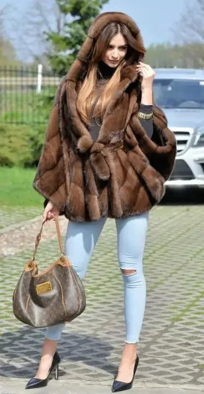 Full-length view of the luxurious hooded faux fur coat on a model, demonstrating its chic batwing sleeve design and high street fashion appeal.