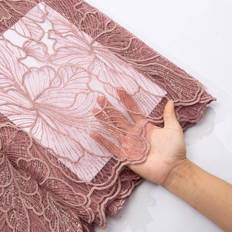 Luxurious African Milk Silk Mesh Lace Fabric with Sequins, perfect for elegant Nigerian wedding dresses, showcasing intricate embroidery and tulle design.