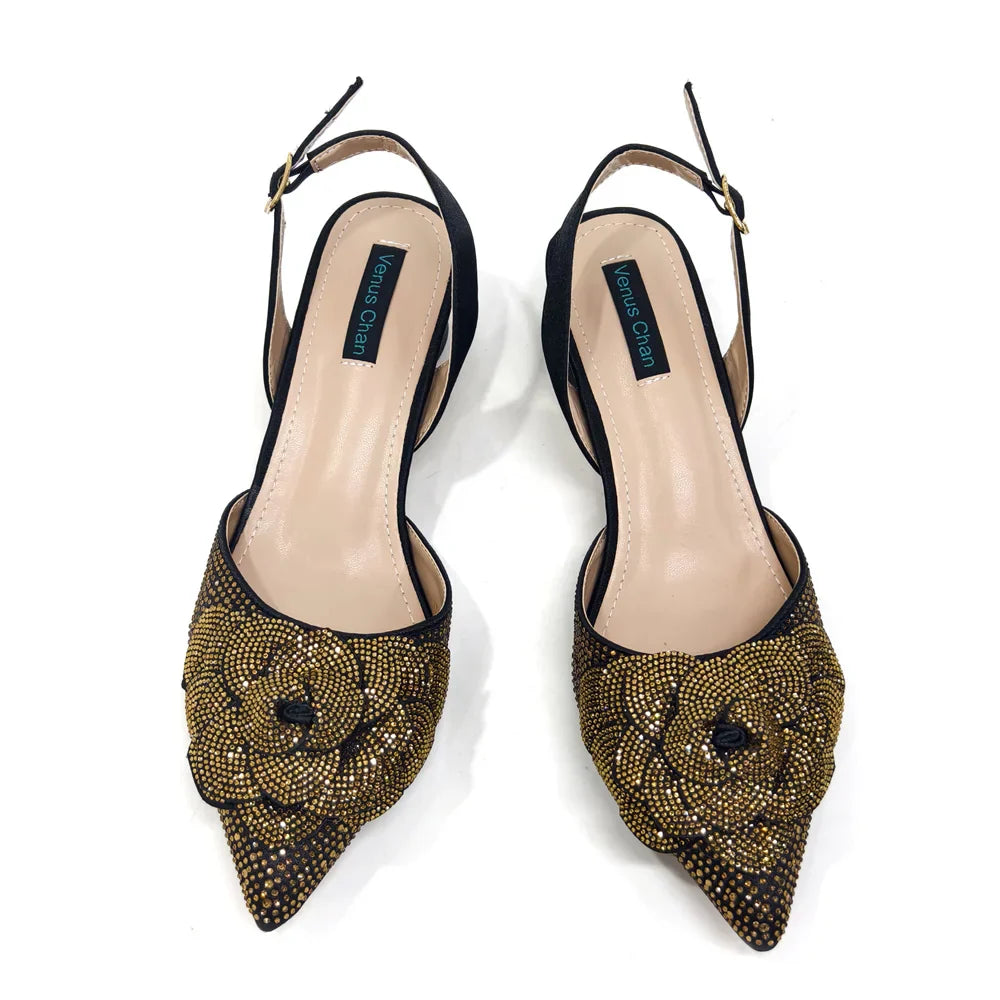 Glamorous bag with a metal handle and long chain shoulder strap, beautifully complements the pointed-toe pumps for a cohesive look.