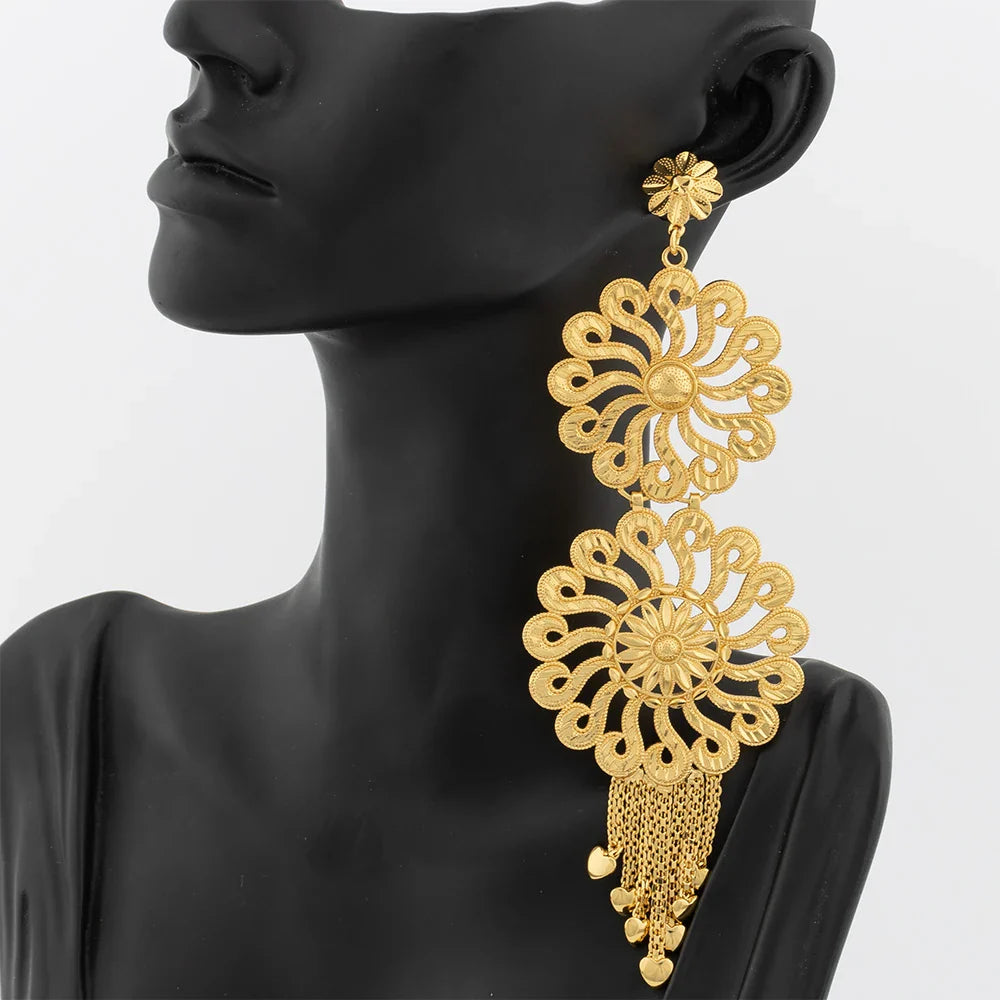 Luxurious 18K gold plated drop earrings adorned with a big copper tassel, designed to add a touch of sophistication to any outfit.