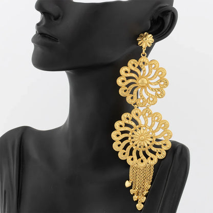 Luxurious 18K gold plated drop earrings adorned with a big copper tassel, designed to add a touch of sophistication to any outfit.