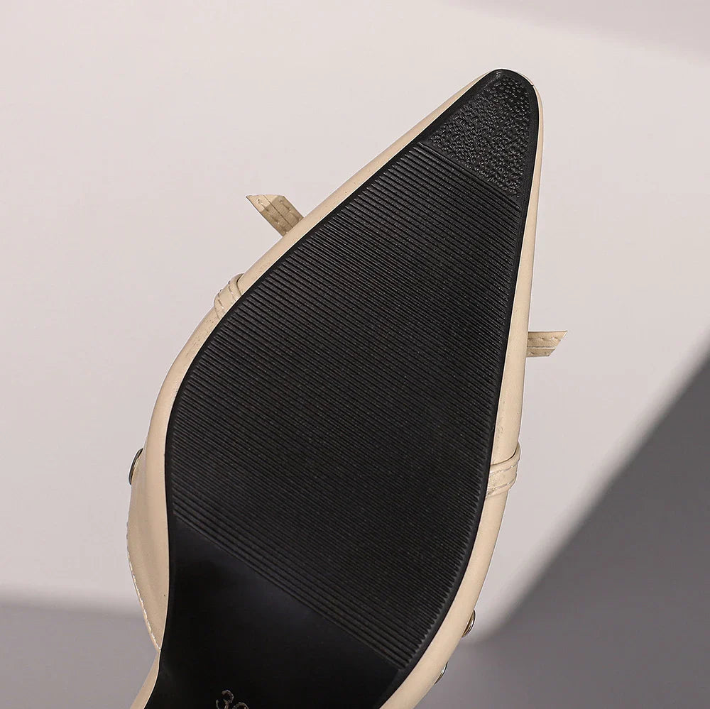 Stylish slip-on high heel sandals for women, designed with a sophisticated metal decoration and a classic silhouette.