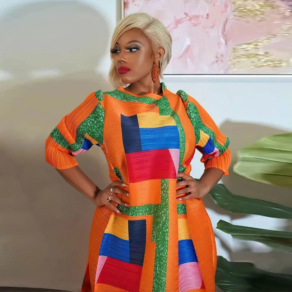 Luxurious African-inspired Plus Size dress in rich colours, showcasing exquisite pleats and tailored 3/4 sleeves for a sophisticated look.