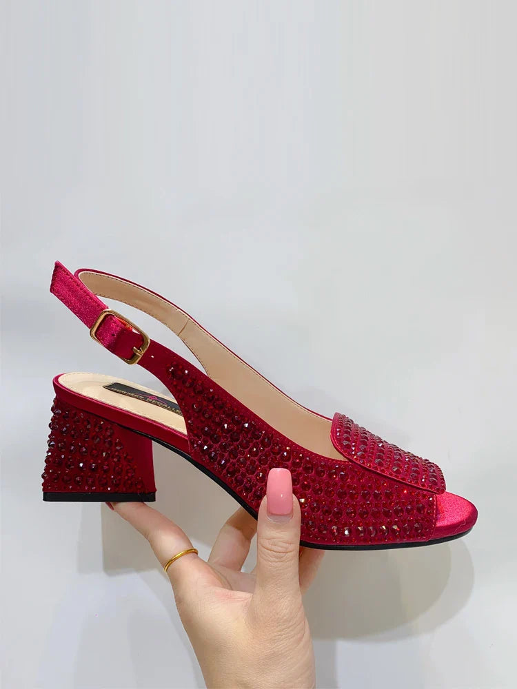 Close-up view of the exquisite bling detailing on gold peep toe women's pumps with a high square heel, designed for fashion-forward women.