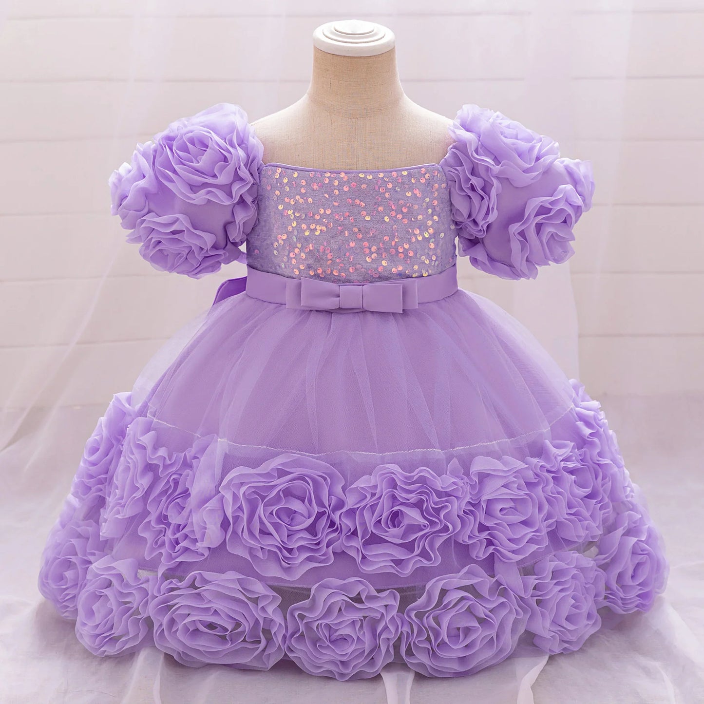 Charming floral appliques adorn this luxurious tulle princess dress for girls aged 4-10, available in several sophisticated colours.