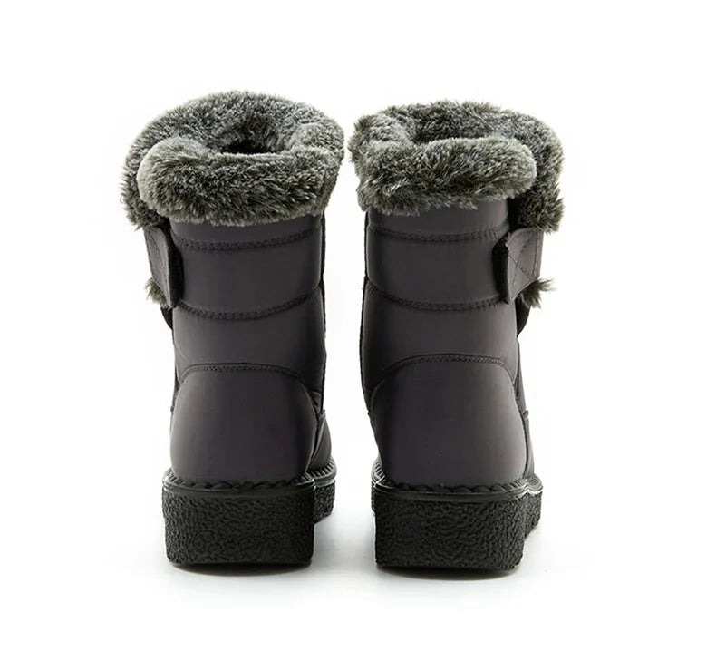 Elegant and chic luxury women's winter snow boots with a round toe and wedge heel, perfect for cold weather outfits.