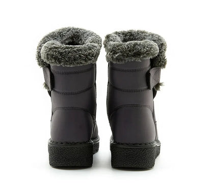 Elegant and chic luxury women's winter snow boots with a round toe and wedge heel, perfect for cold weather outfits.