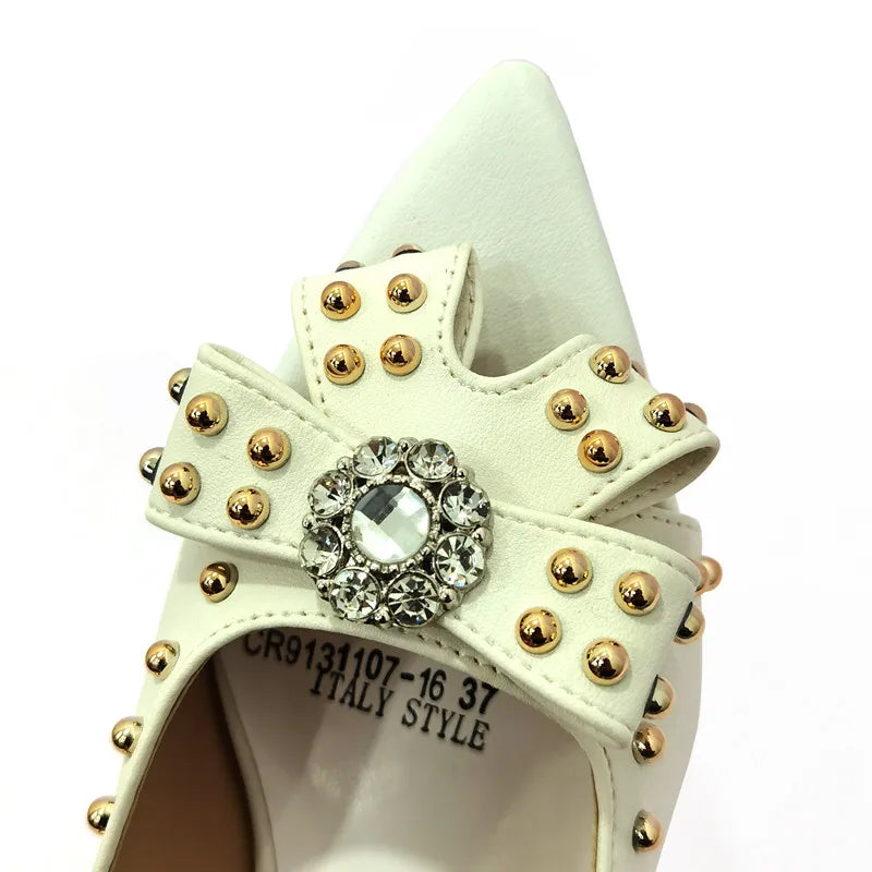 Stylish women's pump shoes and bag set displayed together, embodying elegance with a trendy rivet detail for distinguished flair.