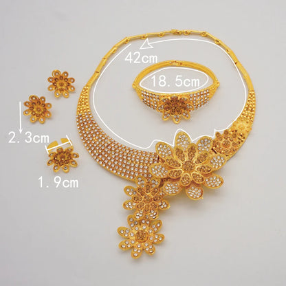 Complete luxury Dubai gold jewellery set for women displayed artistically, including necklace, earrings, bracelet, and ring.