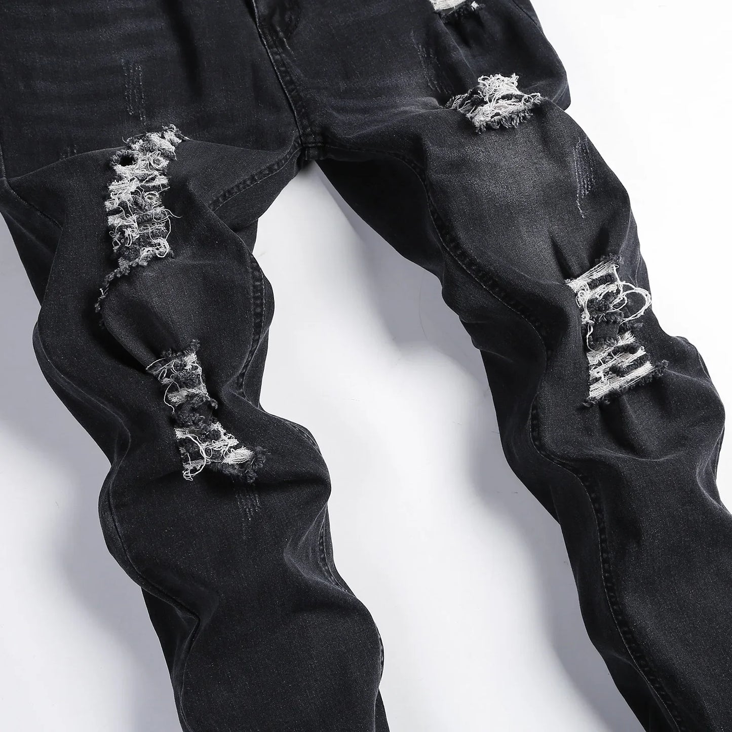 Elegant and durable Luxury Men's Ripped Skinny Jeans with a mid-rise waist, ideal for a sophisticated casual ensemble.
