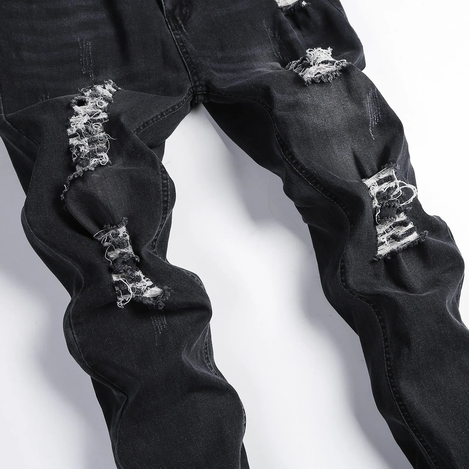 Elegant and durable Luxury Men's Ripped Skinny Jeans with a mid-rise waist, ideal for a sophisticated casual ensemble.