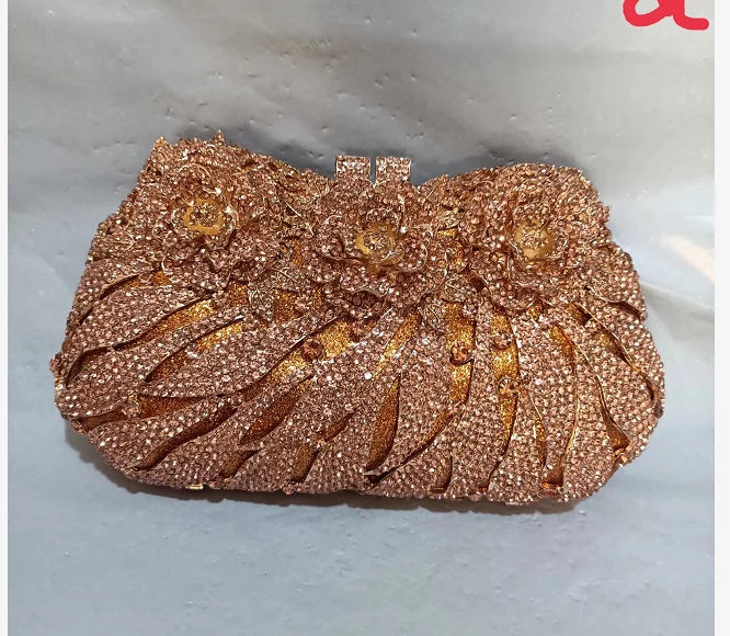 Elegant women's rhinestone-clad evening clutch bag showcasing a sophisticated metallic finish for evening wear.