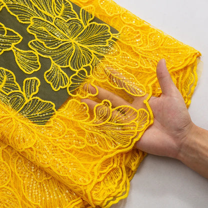 Luxurious embroidered tulle featuring African-inspired design, perfect for creating stunning wedding gowns, with a width of 51-52 inches.