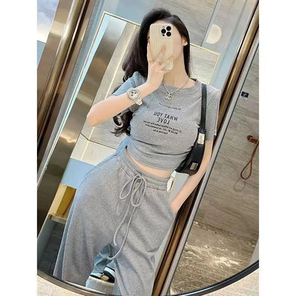 Stylish women's two-piece ensemble showcasing a comfortable short sleeve top paired with breathably designed wide leg pants, perfect for summer.