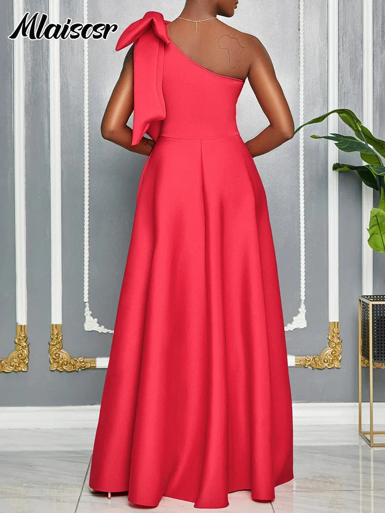 Floor-length red African pleated gown designed by Mlaiscsr with a diagonal collar and sleeveless one-shoulder style, ideal for evening elegance.