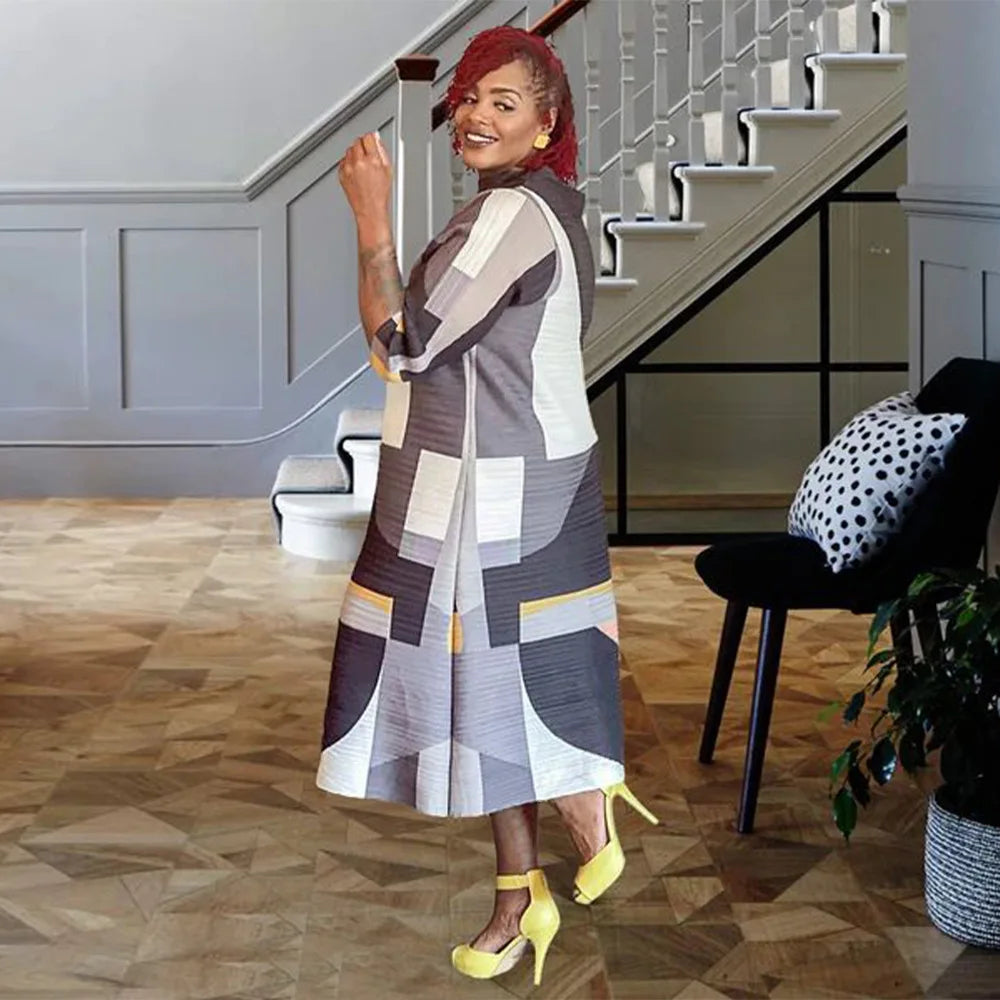 Elegant African plus size O-neck pleated long dress with 3/4 sleeves, featuring traditional Dashiki design in vibrant colours.