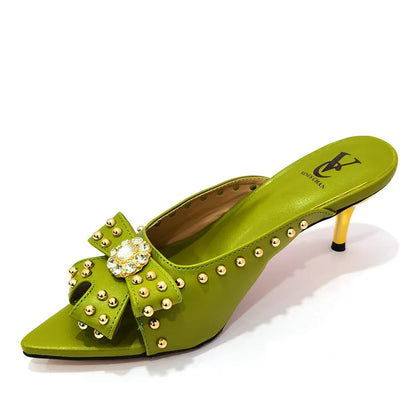 Elegant women's high heeled shoes with rivet design in vibrant colour, showcasing luxurious craftsmanship and style.