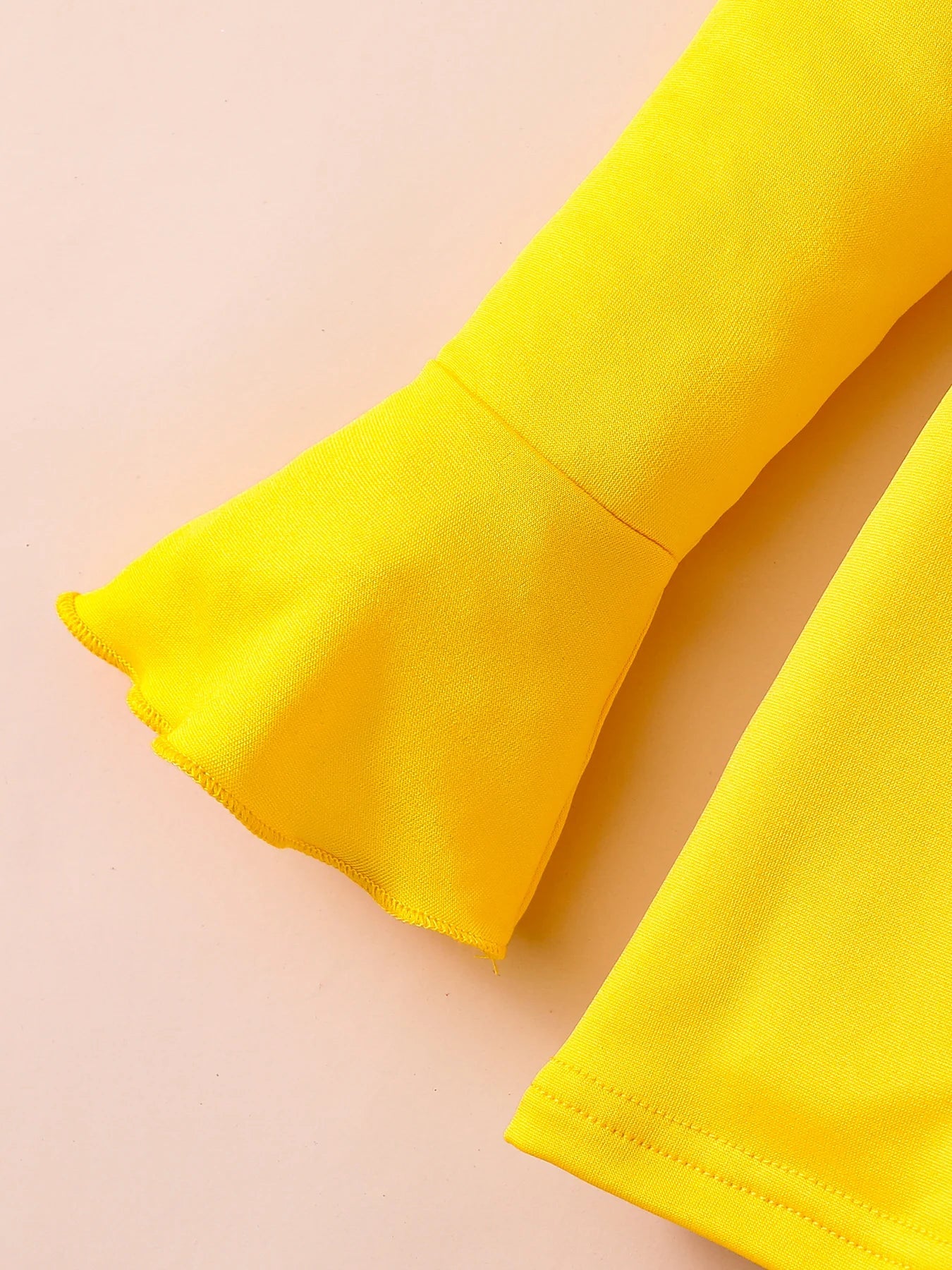 Glamorous illustration of a girls' spring fashion set, featuring a solid flared sleeve top and eye-catching printed tights, ideal for stylish 4-6Y girls.