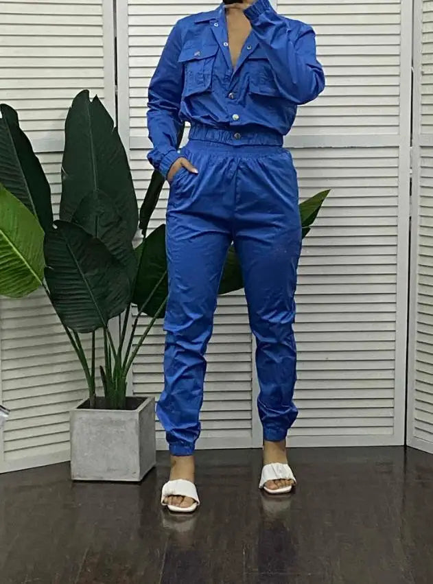 Fashionable woman wearing an elegant two-piece denim style tracksuit, ideal for contemporary office attire.