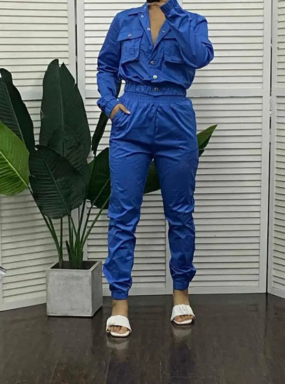 Fashionable woman wearing an elegant two-piece denim style tracksuit, ideal for contemporary office attire.