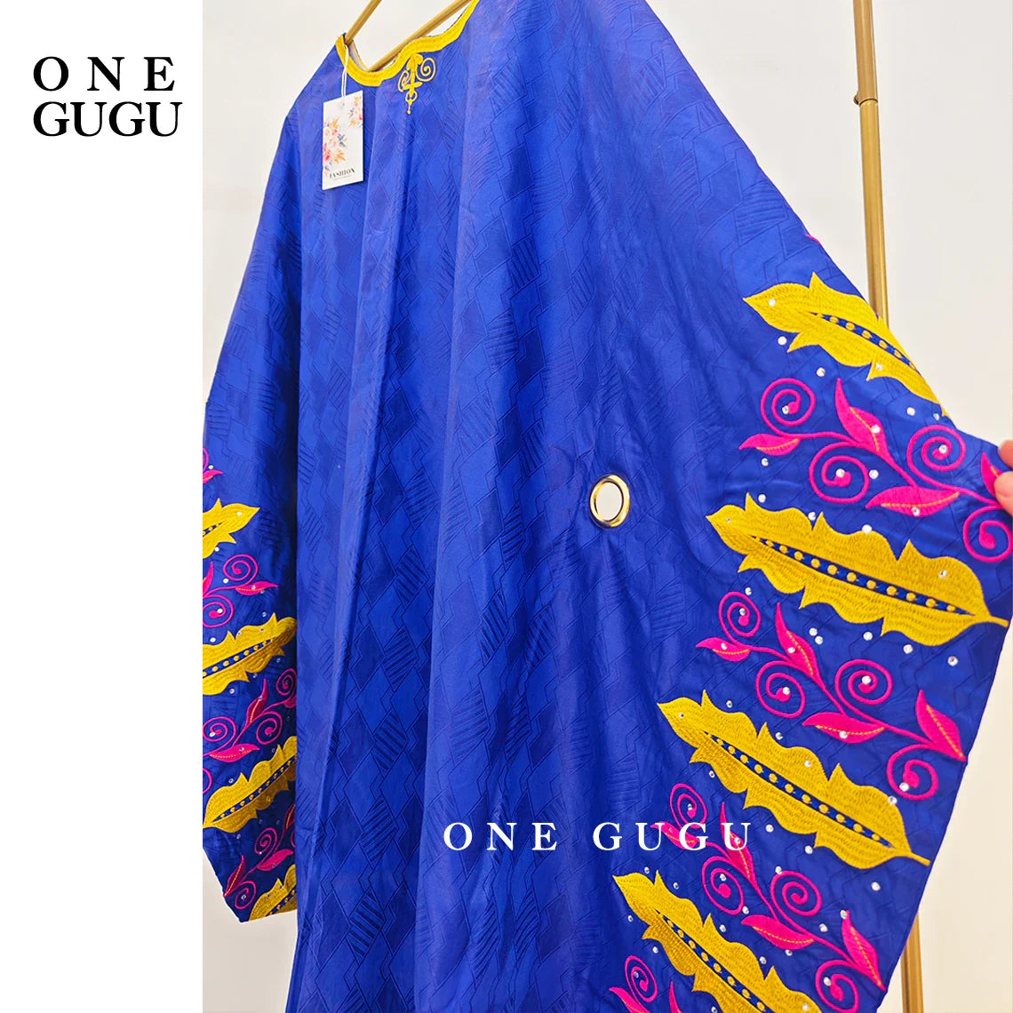 Close-up of the rich fabric texture and decoration of the Nigerian party gown, crafted from cotton and polyester.