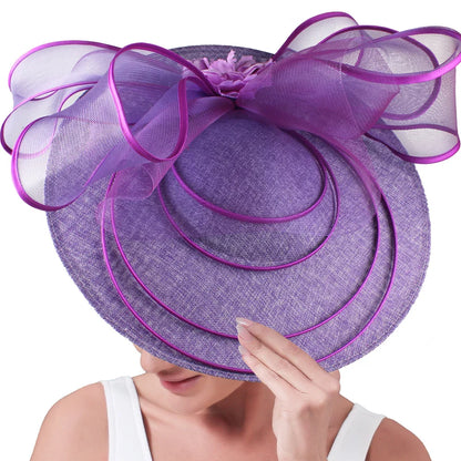 Fashionable large fascinator hat elegantly worn at a garden party, highlighting its exquisite craftsmanship and style.