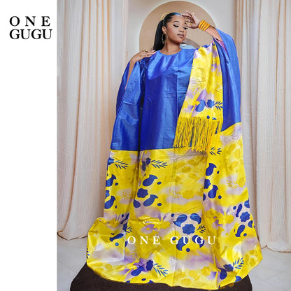 Luxury African Dashiki wedding dress in rich blue Bazin Riche fabric with intricate embroidery and lace details, perfect for weddings and special events.