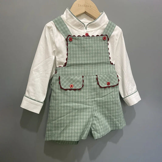 Close-up of luxury cotton fabric featuring a soft white shirt, styled with premium green plaid trousers for toddlers, perfect for a sophisticated appearance.