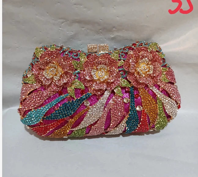 Luxury women's metallic minaudiere evening clutch bag adorned with rhinestones, perfect for formal parties.
