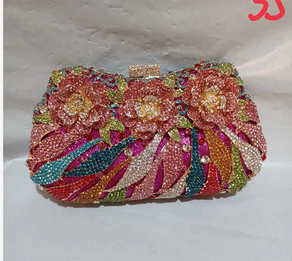 Luxury women's metallic minaudiere evening clutch bag adorned with rhinestones, perfect for formal parties.