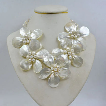 Stylish women's jewelry set featuring a shell flower necklace and elegant earrings, embellished with crystals for a luxurious wedding accessory.