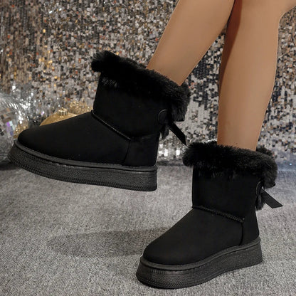 Chic and modern women's slip-on snow boots with flat heel, made from high-quality microfiber, ideal for casual winter outings.