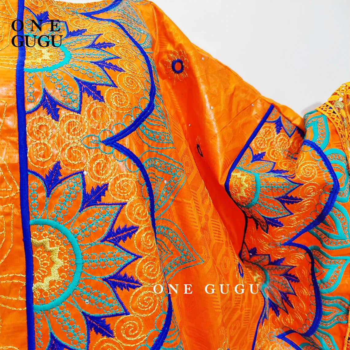 Front view of a stunning orange Nigerian dress with decorative embroidery lace, tailored for women seeking elegance.