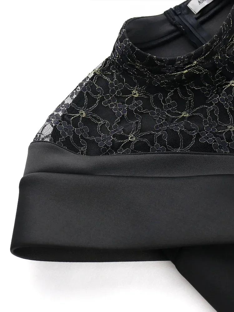 Sophisticated black lace evening gown, showcasing a form-fitting silhouette and intricate patchwork details, perfect for upscale occasions.