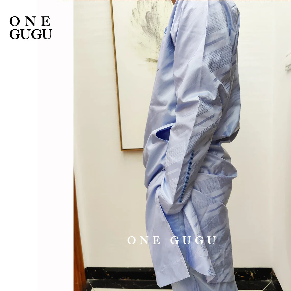 Model wearing a premium waterproof African two-piece set, showcasing a luxurious blue cotton Dashiki outfit for men, ideal for celebrations.