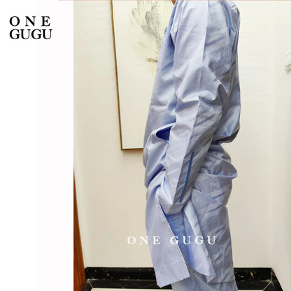 Model wearing a premium waterproof African two-piece set, showcasing a luxurious blue cotton Dashiki outfit for men, ideal for celebrations.