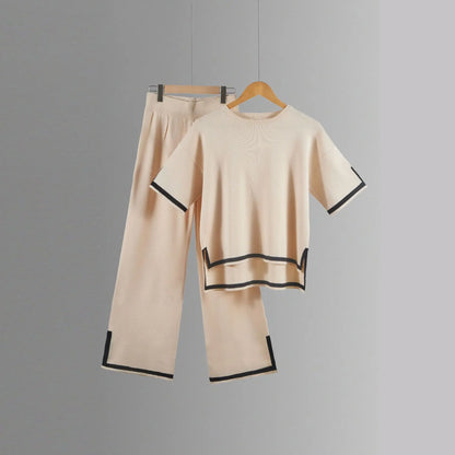 Stylish women’s knitted trousers suit showcasing a loose fit with ankle-length wide-leg pants and a chic short-sleeved pullover, perfect for sophisticated casual wear.