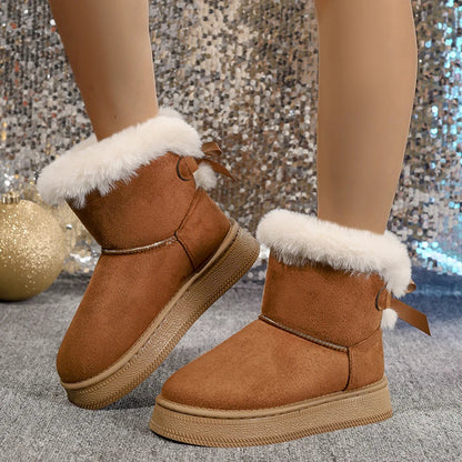 Elegant women's snow boots featuring a chic bow design, mid-calf height, and a round toe, crafted from luxurious solid microfiber, perfect for winter fashion.