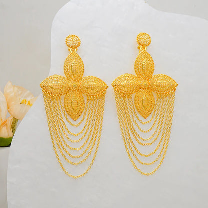 Stunning geometric African gold drop earrings showcased on a velvet background, highlighting their trendy bohemian style.