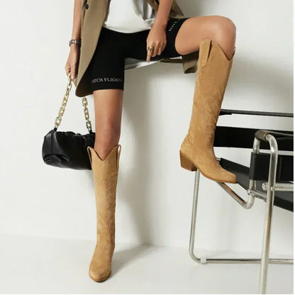 Side view of sophisticated knee-high pointed toe boots in brown PU leather, inspired by Western cowboy fashion.