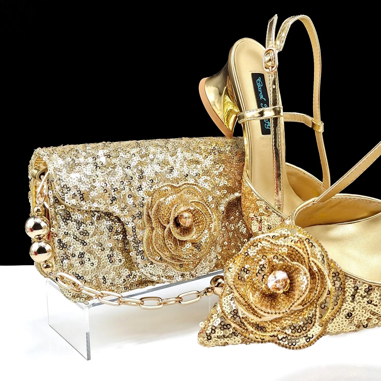 Close-up of QSGFC gold wedding shoes showcasing exquisite rhinestone and metal decoration, designed for brides.