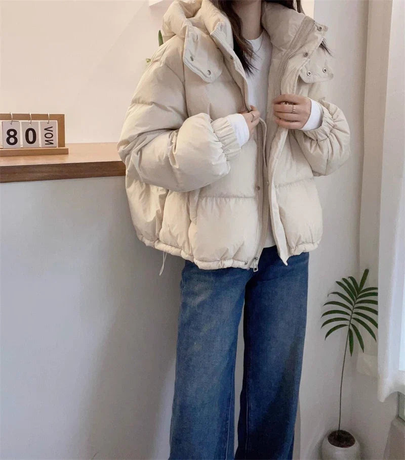 Luxurious women's slim fit hooded puffer jacket crafted from premium cotton and polyester blend, designed for warmth during autumn and winter.