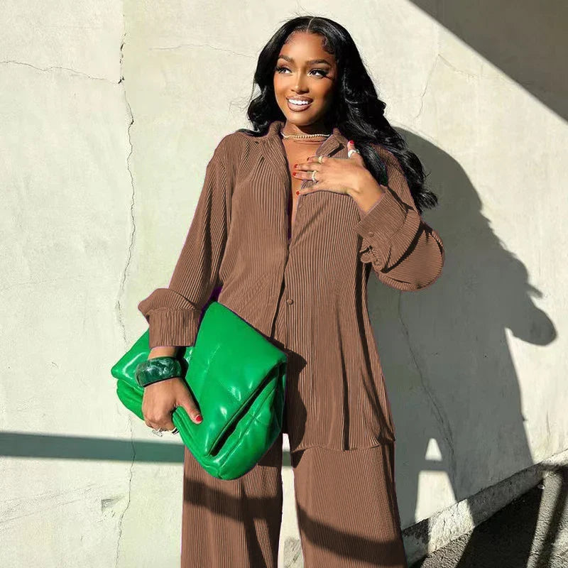 Versatile autumn/winter outfit set featuring a draped elegant shirt and tailored high waist trousers, a must-have for luxury wardrobes.