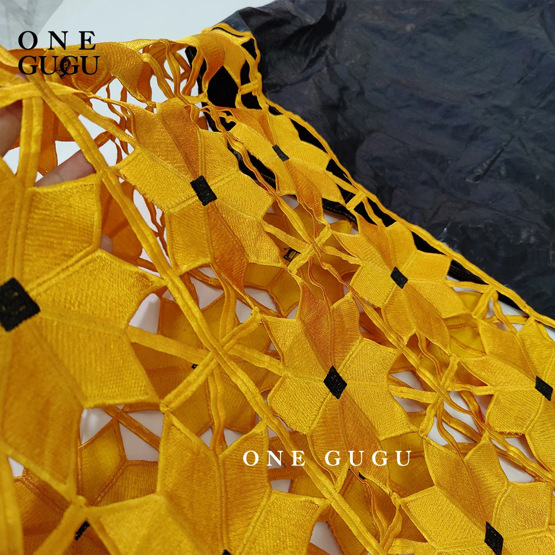 Stylish African Bazin dress displayed elegantly, showcasing its exquisite embroidery and luxurious fabric in a plus size long sleeve design.