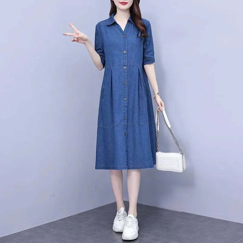 Stylish overhead view of the oversized 5XL denim dress with short sleeves, emphasising its sleek pockets and refined A-line shape, perfect for modern women seeking comfort and elegance.