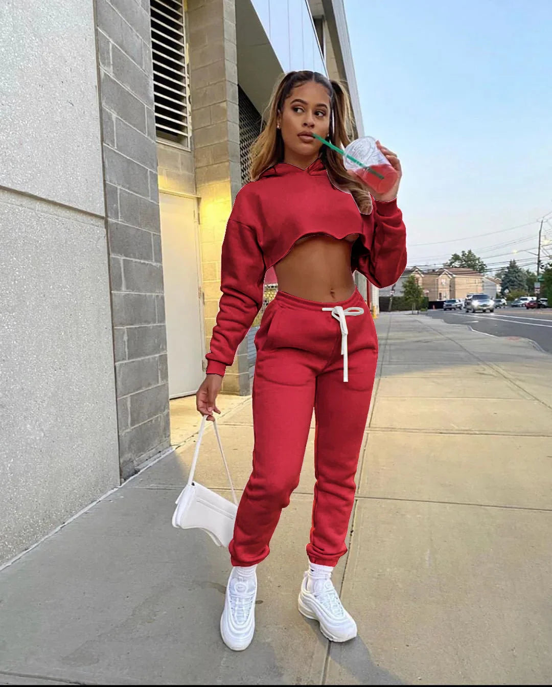Luxury women's pink fleece running set featuring a long sleeve cropped hoodie and jogger tracksuit, elegantly spliced design for a trendy look.