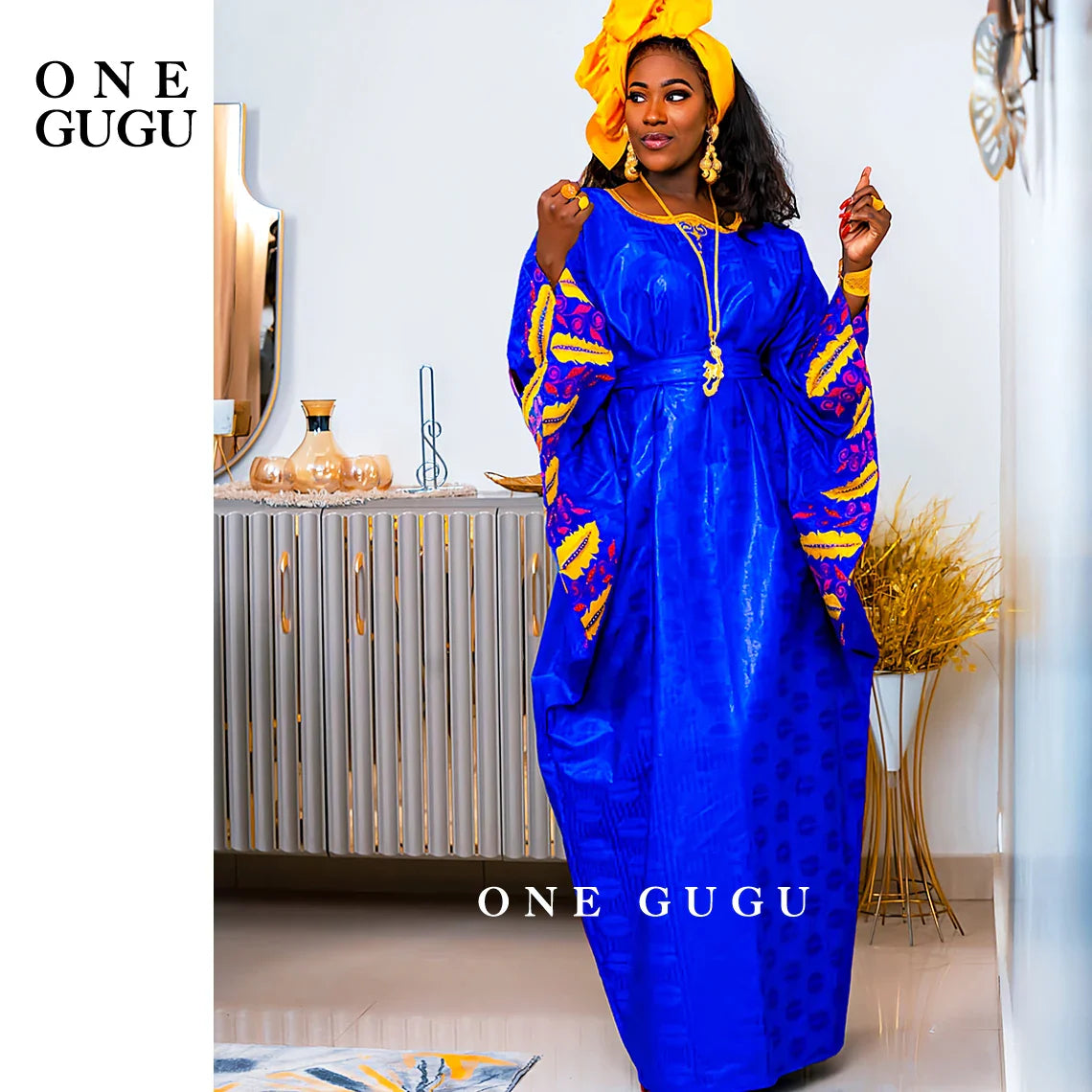 Elegant Royal Blue African Bazin Riche Boubou Dress showcased for women, perfect for Nigerian weddings featuring intricate embroidery and luxurious design.