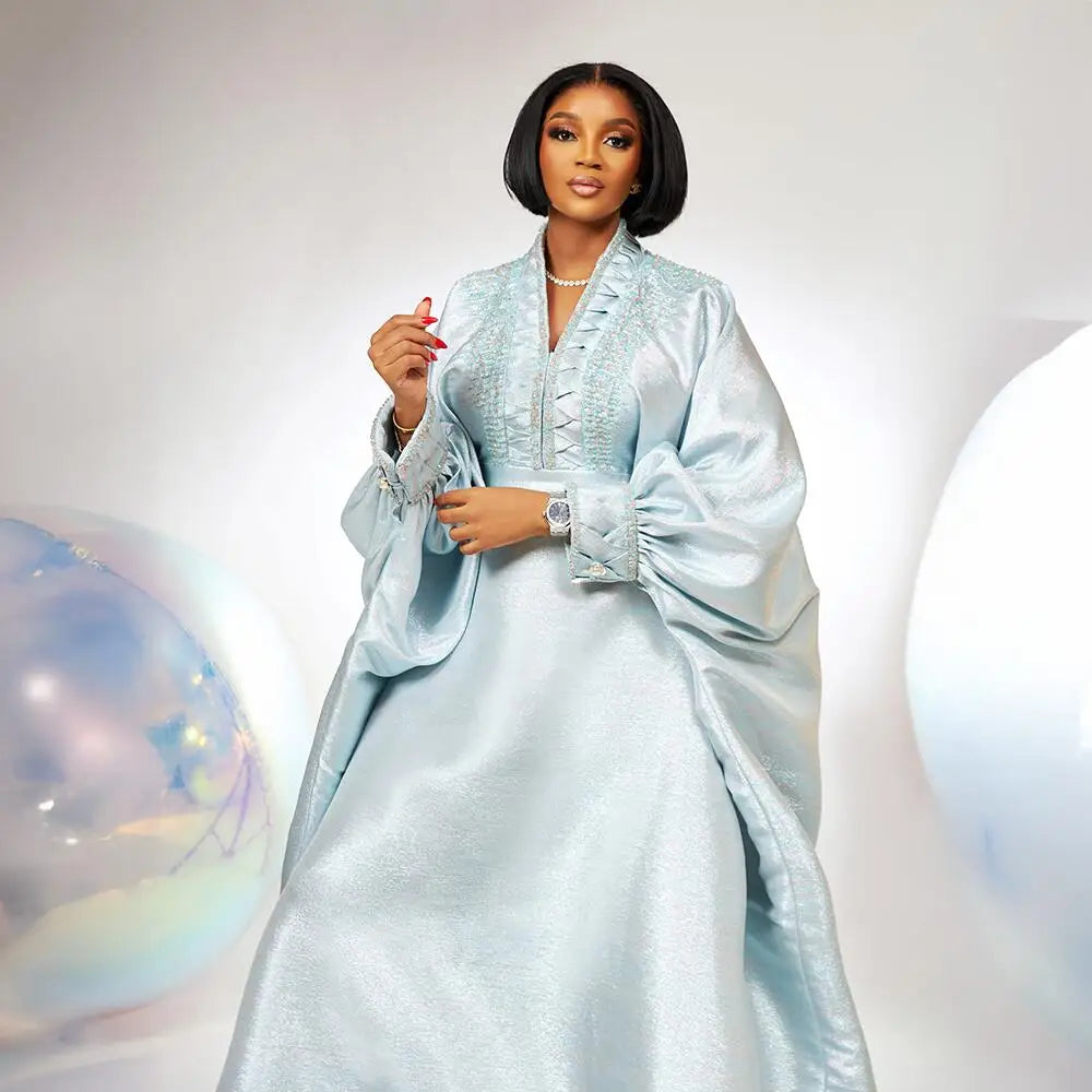 Sophisticated luxury dress featuring an elegant V-neck and intricate rhinestone embellishments, designed for women celebrating African heritage in style.